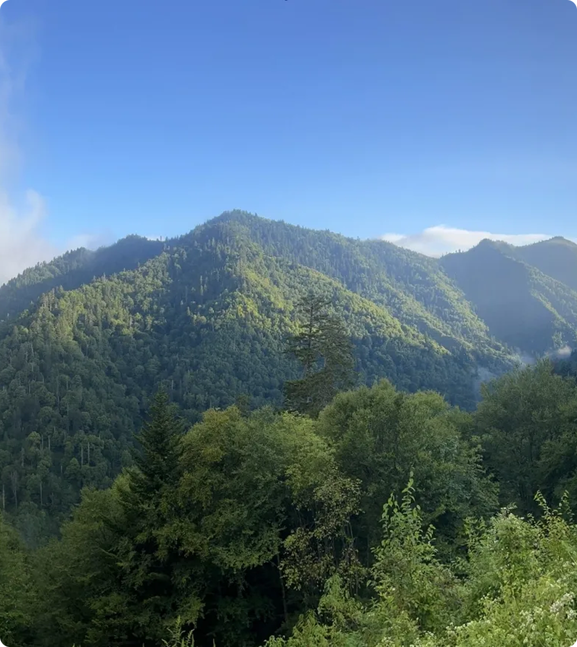 Sunlit mountains under blue sky